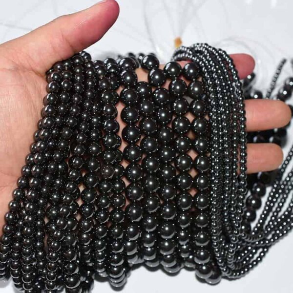 Hand displaying Hematite Beads for DIY jewelry projects, strong metallic shine