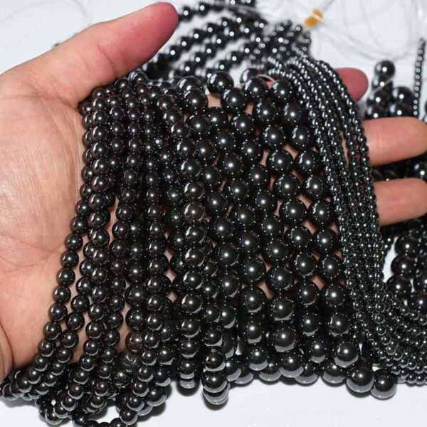Natural Hematite Beads strands for jewelry crafting, hand-held close-up