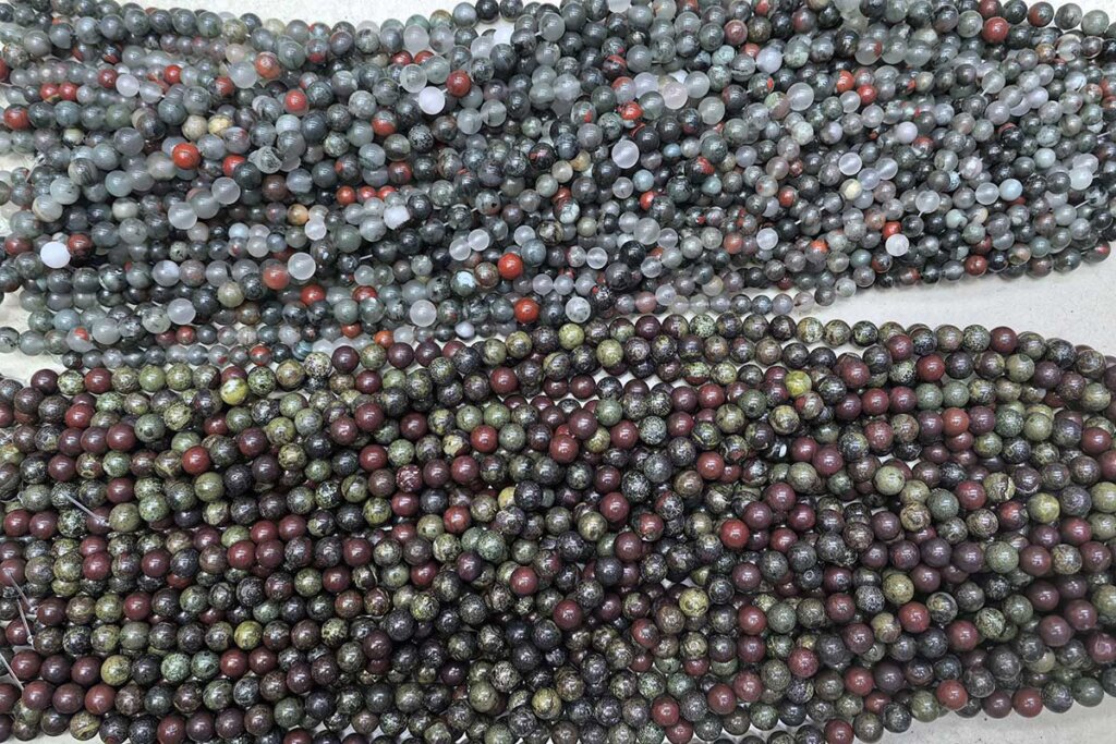 African Bloodstone Meaning illustrated with polished beads compared to Dragon Blood Jasper