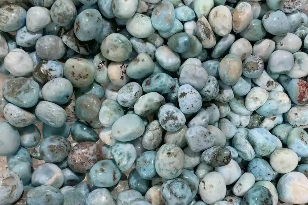 Basket filled with natural larimar stones, showcasing larimar stone benefits