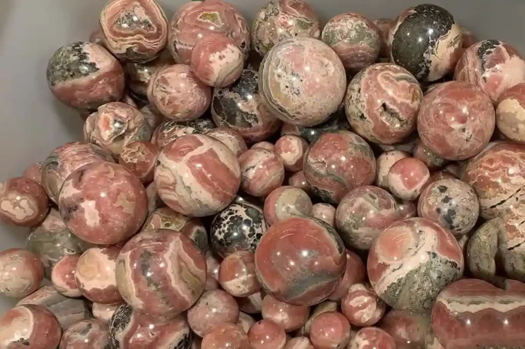 Rhodonite vs Rhodochrosite polished stones – natural Rhodochrosite Ball