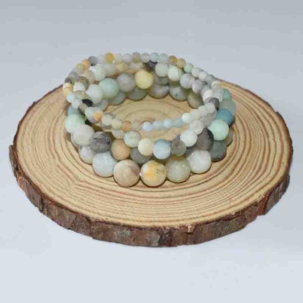 Handcrafted Matte Amazonite Beaded Bracelet on round wood background