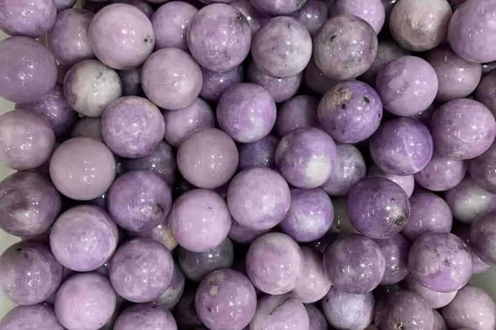 Purple lepidolite gemstone ball showing Lepidolite Meaning and calming crystal energy.