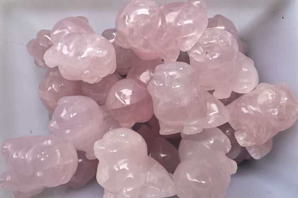 Rose Quartz Carved Pig figurine representing prosperity and joy, associated with rose quartz benefits
