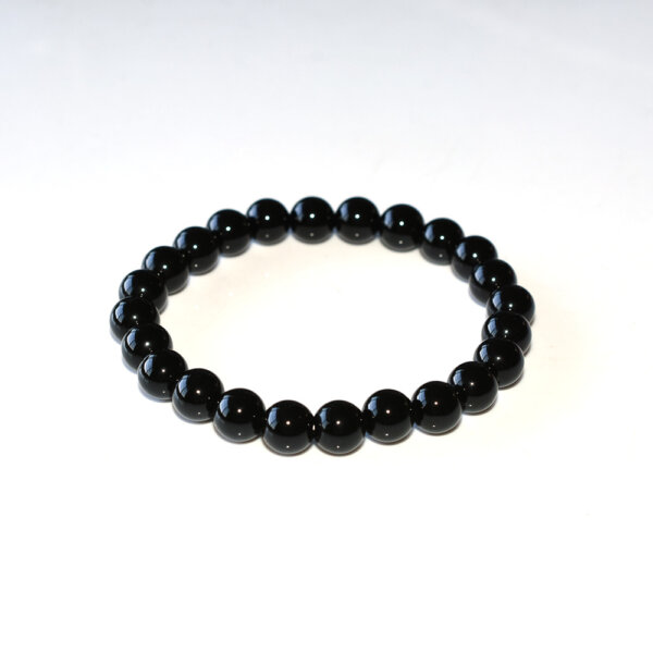 Minimalist black tourmaline bracelet on white background