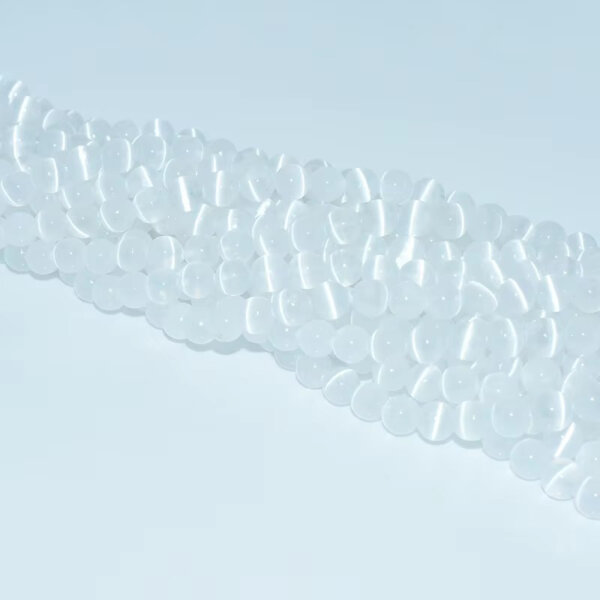Clear selenite beads aligned in multiple straight strands