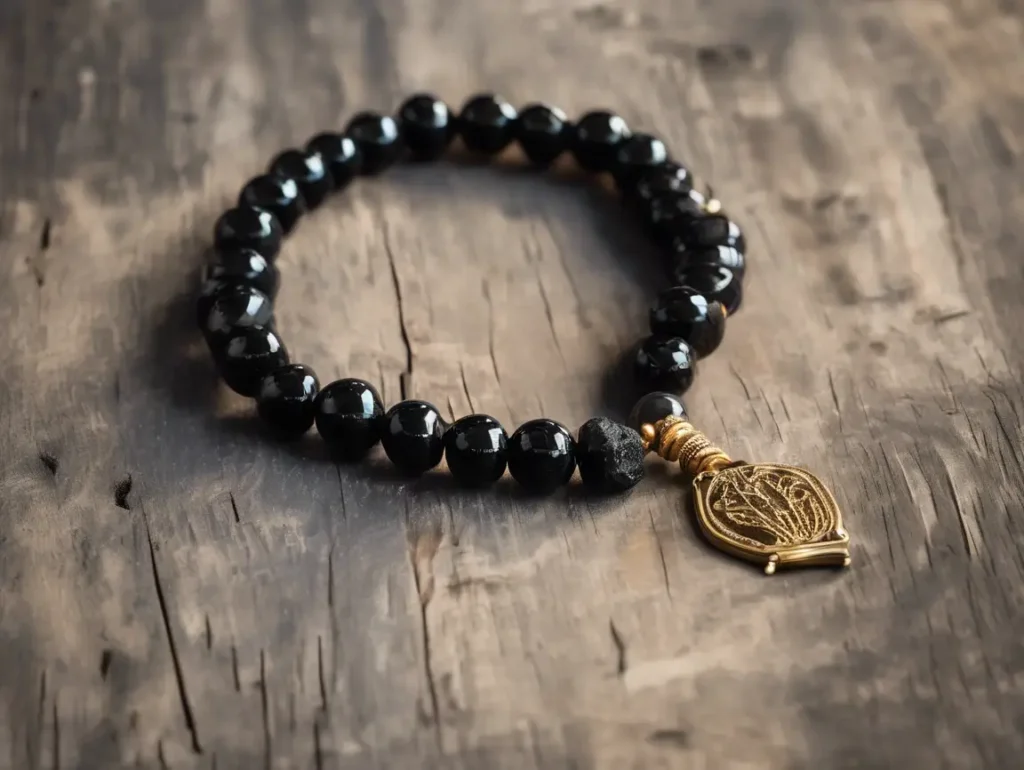 This bracelet with a Hamsa charm highlights black tourmaline bracelet benefits like spiritual defense and chakra balance.