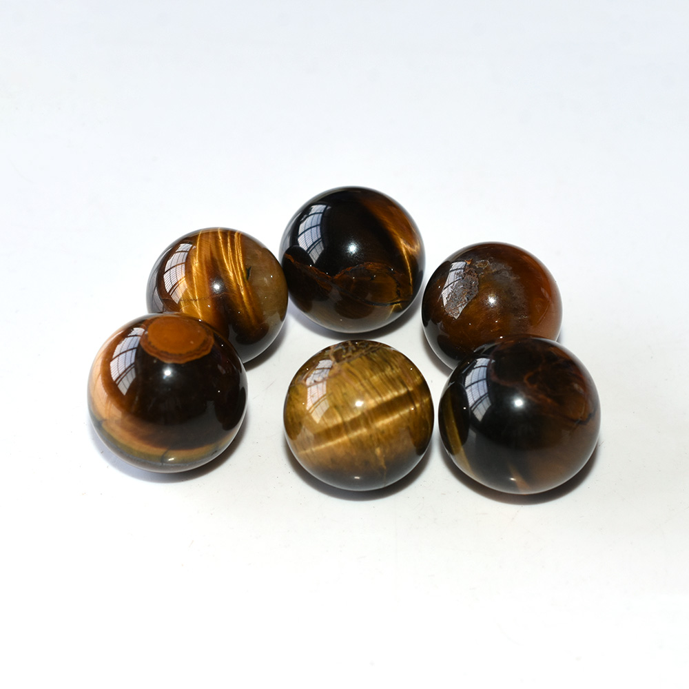 Tiger Eye Spheres arranged in a circle on white background, showcasing golden chatoyancy