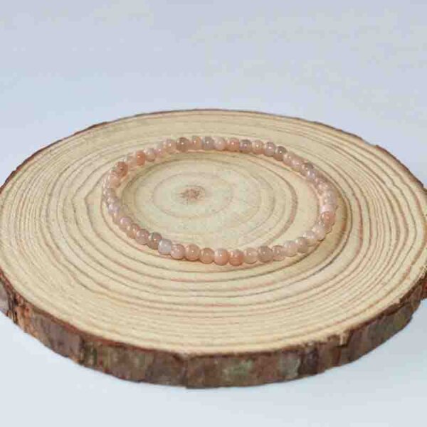 Minimalist wooden jewelry display platform with concentric grain, suitable for crystal products