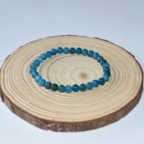 Handmade Blue Apatite Bracelet coiled in double loop on wood background, ideal for energy healing and style