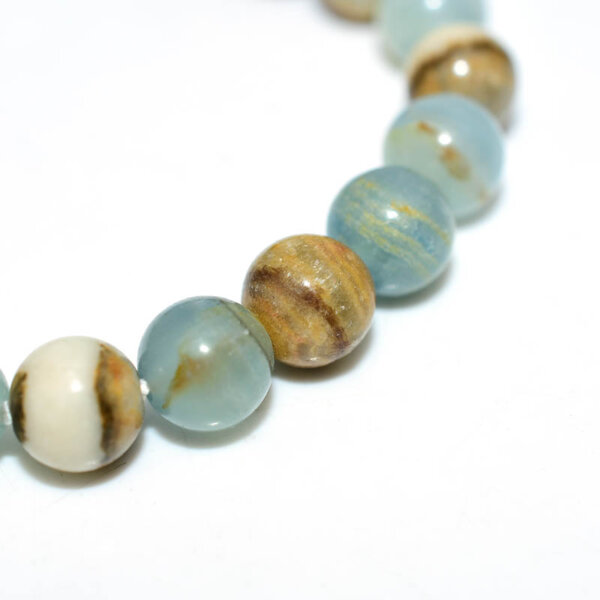 Zoomed view of Blue Calcite beads with polished surface and natural textures