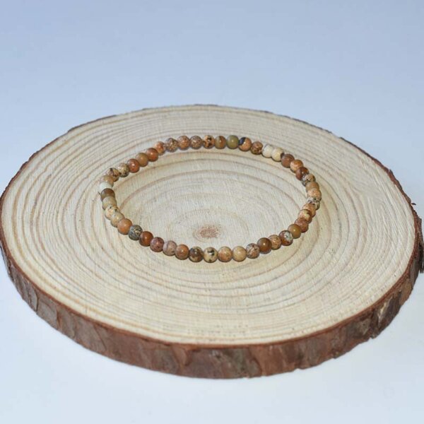 Earth-tone Picture Jasper Bracelet resting on wood display – grounding crystal bracelet