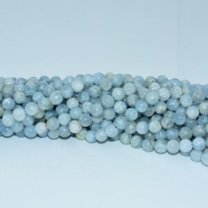 Close-up of celestite bead strands with soft blue-grey hues and icy lines