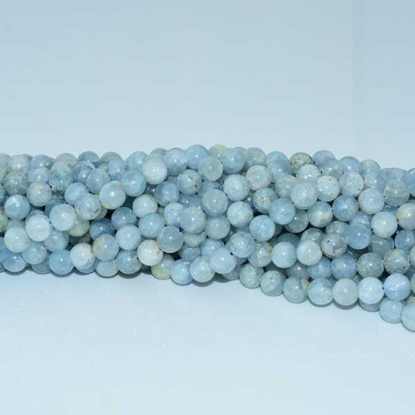 Close-up of celestite bead strands with soft blue-grey hues and icy lines