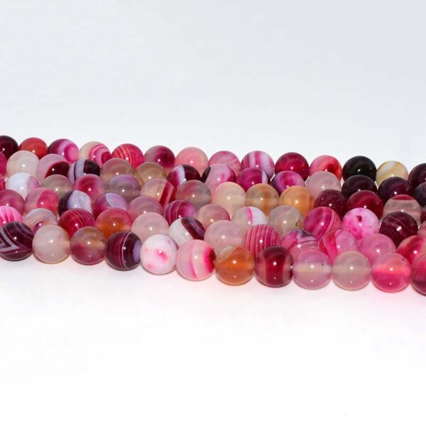 Pink agate beads arranged in a row