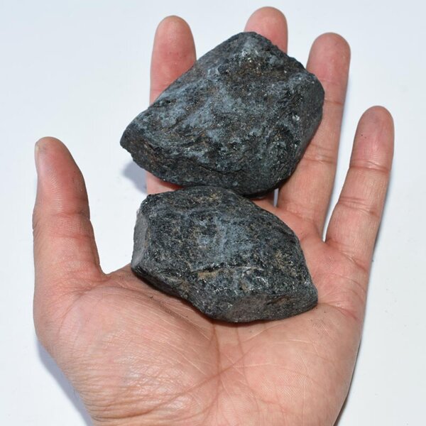 Hand holding three Raw Black Tourmaline stones