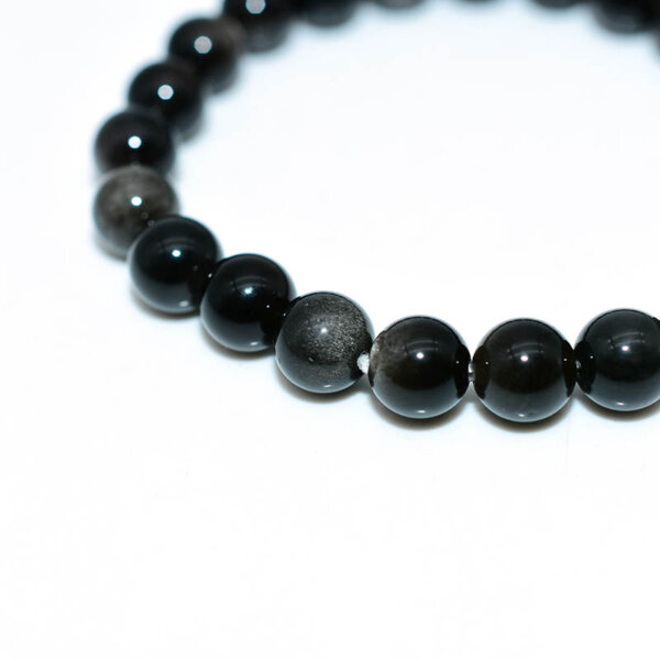 Macro shot of Silver Obsidian Bracelet beads, showing reflective luster