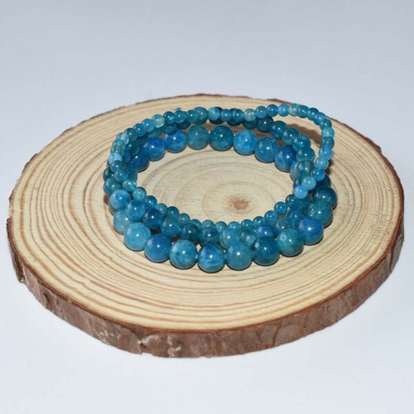 Blue Apatite Bracelet neatly arranged on wooden display, highlighting gemstone clarity and uniform size