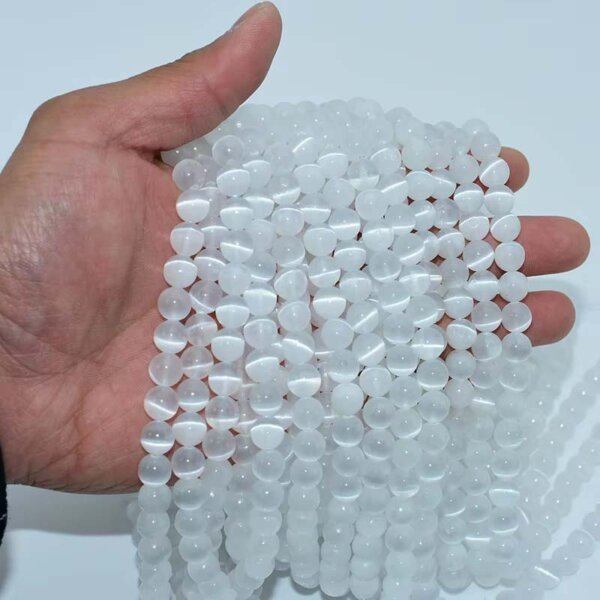 Palm showcasing multiple strands of translucent selenite beads