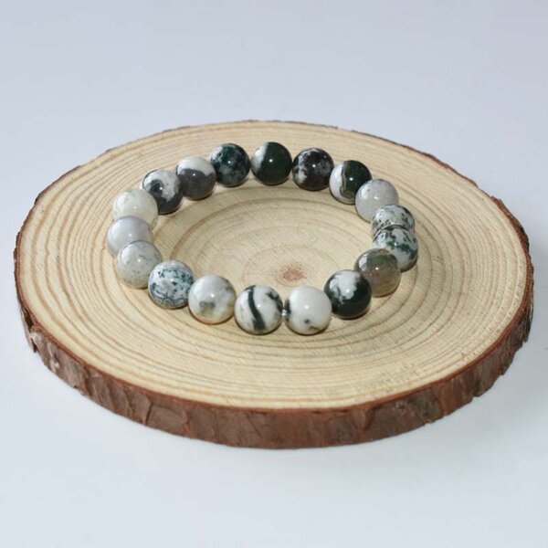 Tree Agate Bracelet with deep green beads – laid on wood disc