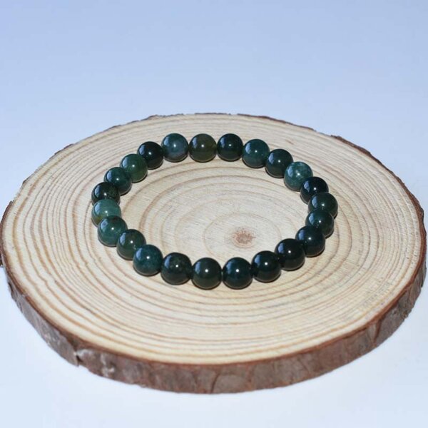 Moss Agate Bracelet with smooth 8mm beads on wooden base