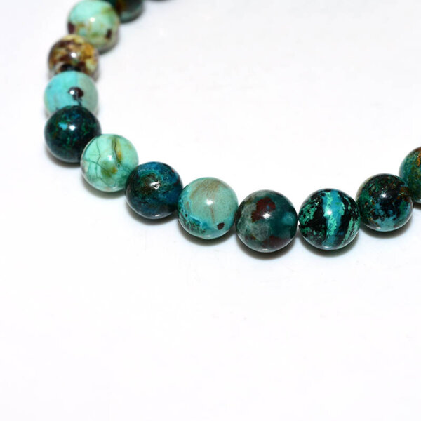 Macro view of Chrysocolla beads with mixed green and teal tones