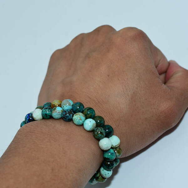 Model wearing Chrysocolla Bracelet on wrist showcasing bead color and size