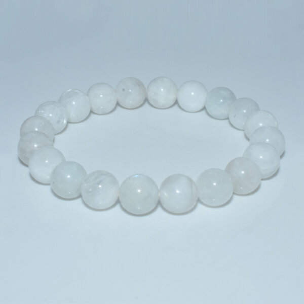 Elegant moonstone bracelet arranged in a circular layout on flat surface