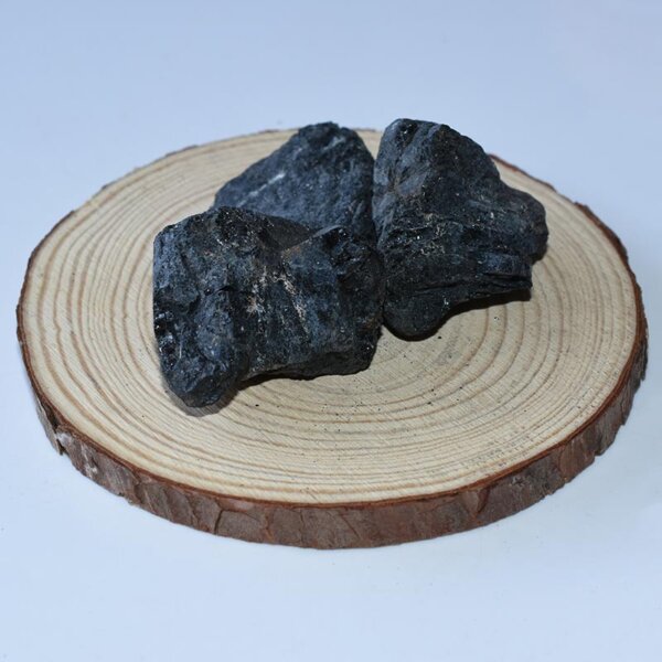 Raw Black Tourmaline displayed on a wood slice 3-5cm