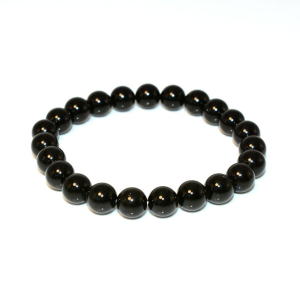 Black Spinel Bracelet arranged in circle on flat surface