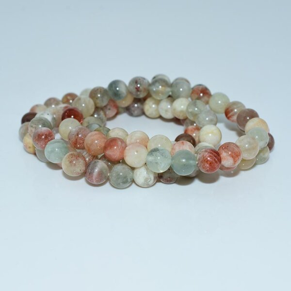 Flat lay of Arusha Sunstone Bracelet with mixed warm-colored gemstones