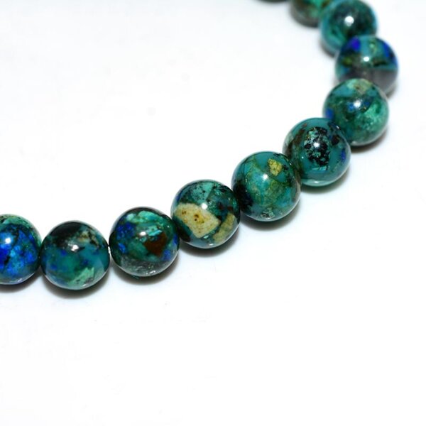 Close-up of Azurite beads showing vivid blue-green patterns and smooth finish