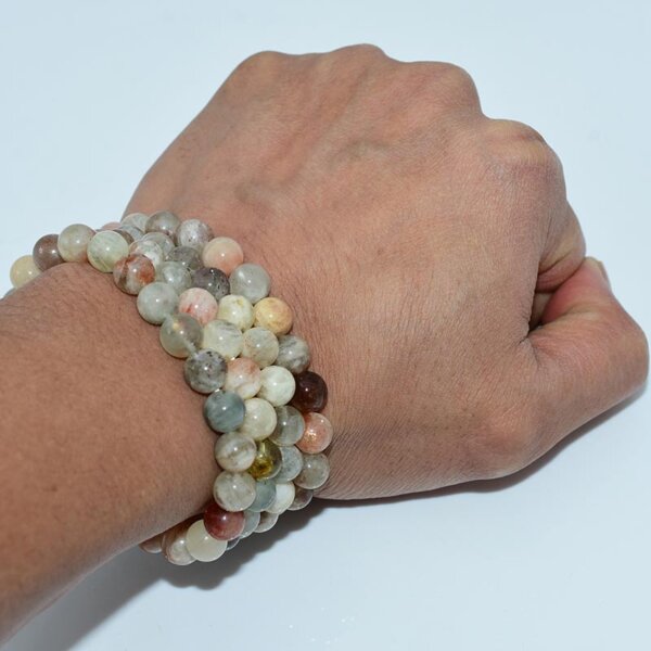 Hand wearing Arusha Sunstone Bracelet showing natural multicolor beads