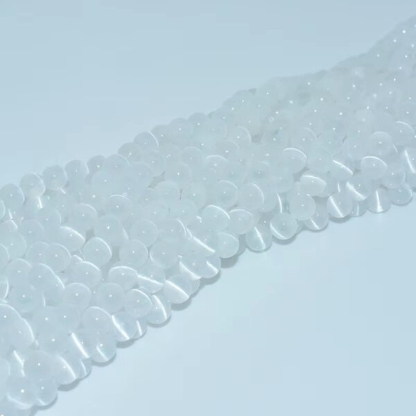 Close-up of natural white selenite beads arranged in strands