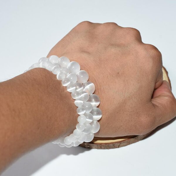 Hand wearing natural selenite bracelet, crystal chip style