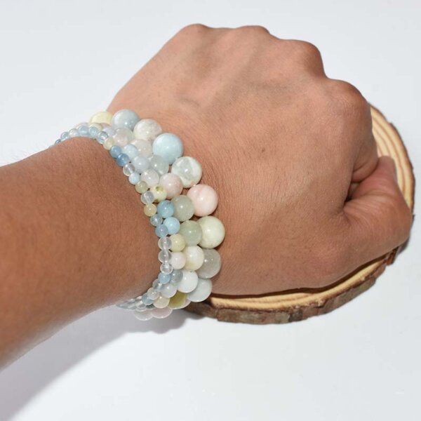 Double Morganite Crystal Bracelets worn on wrist, featuring light pink and aqua green beads, handmade stretch design