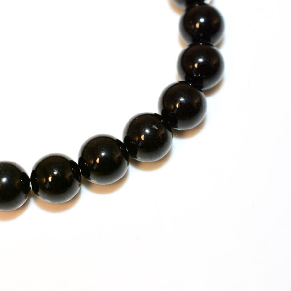 Close-up of polished Black Spinel beads showing glossy texture
