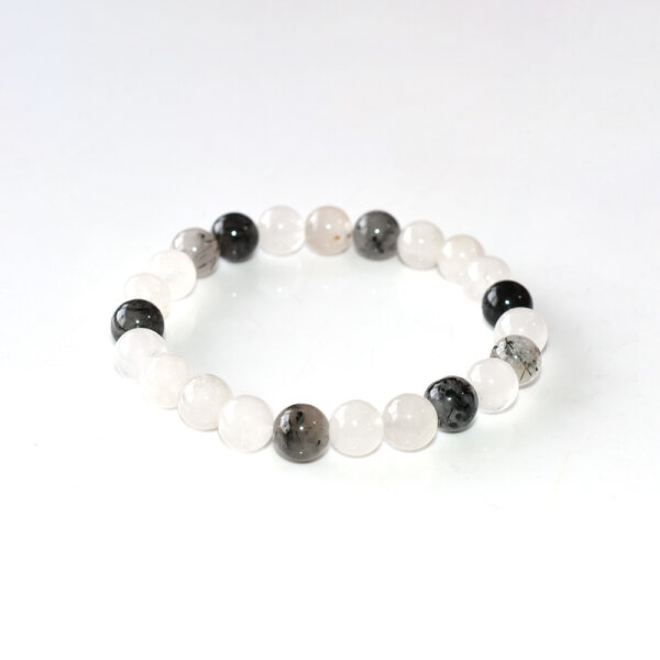 Black Rutilated Quartz bracelet with clear and black beads on white background