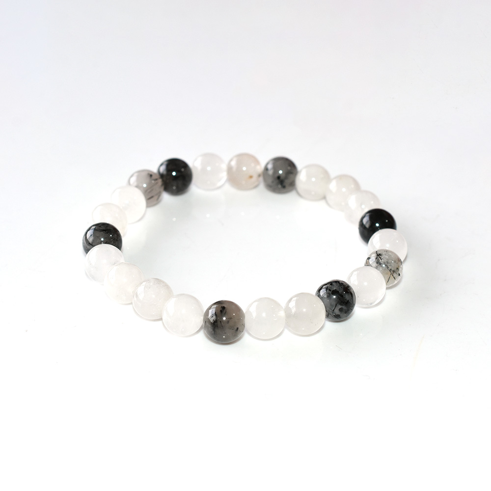 Black Rutilated Quartz bracelet with clear and black beads on white background