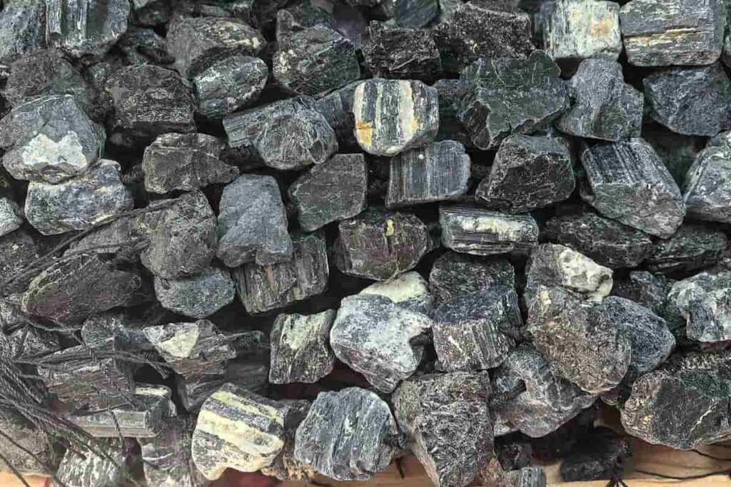 Natural raw Black Tourmaline strand beads showing rough texture, representing protection and purification in Black Tourmaline meaning.