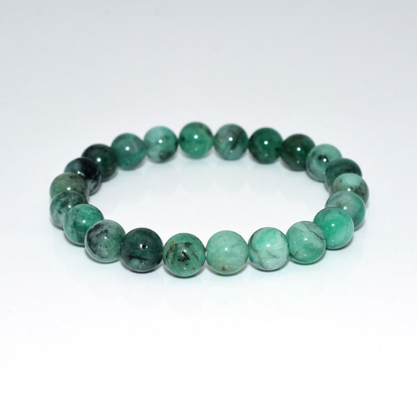 Emerald bracelet with natural green gemstone beads on white background
