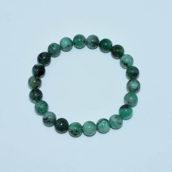 Top-down view of circular emerald bracelet layout