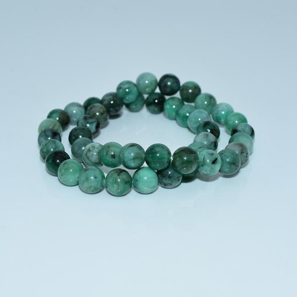Side angle of emerald bracelet with deep green luster