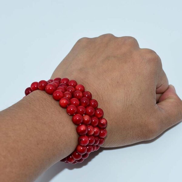 Red Coral Bracelet worn on wrist – natural vibrant red gemstone beads