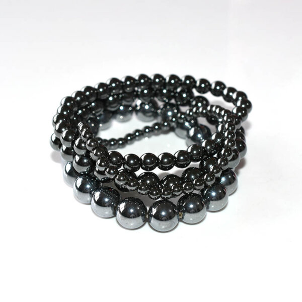 Multiple Hematite Bracelets stacked together on white background