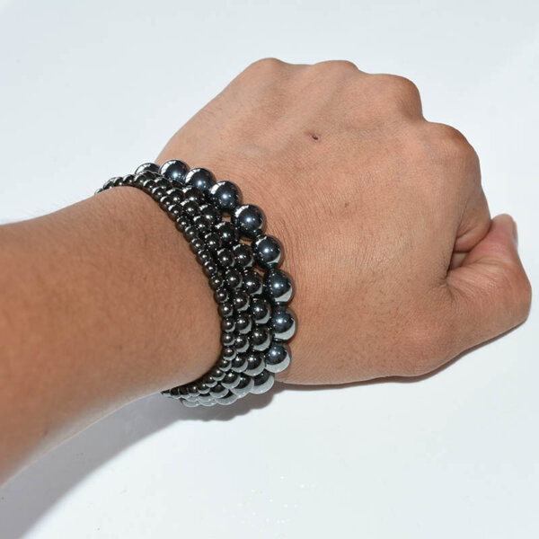 Hand wearing double strand Hematite Bracelet with polished round beads