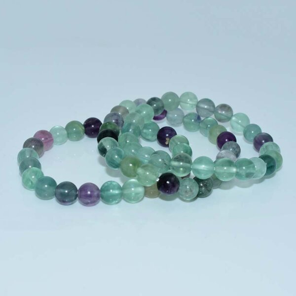 Fluorite crystal bracelets stacked to showcase color variety and translucency