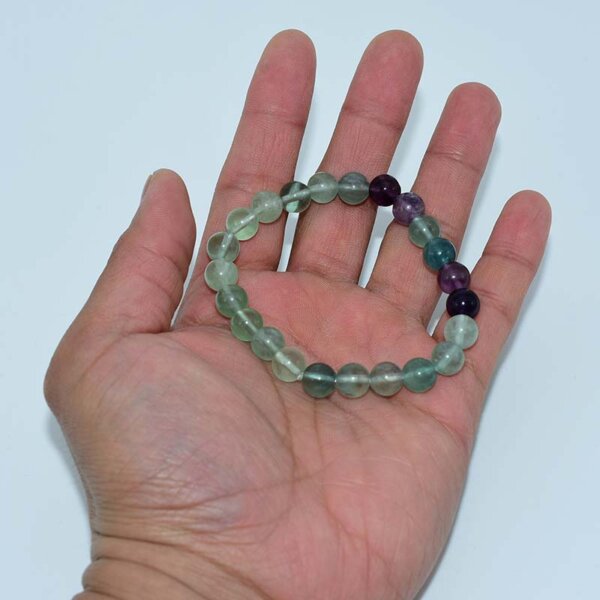 Fluorite crystal bracelet displayed on hand, showing bead size and color mix