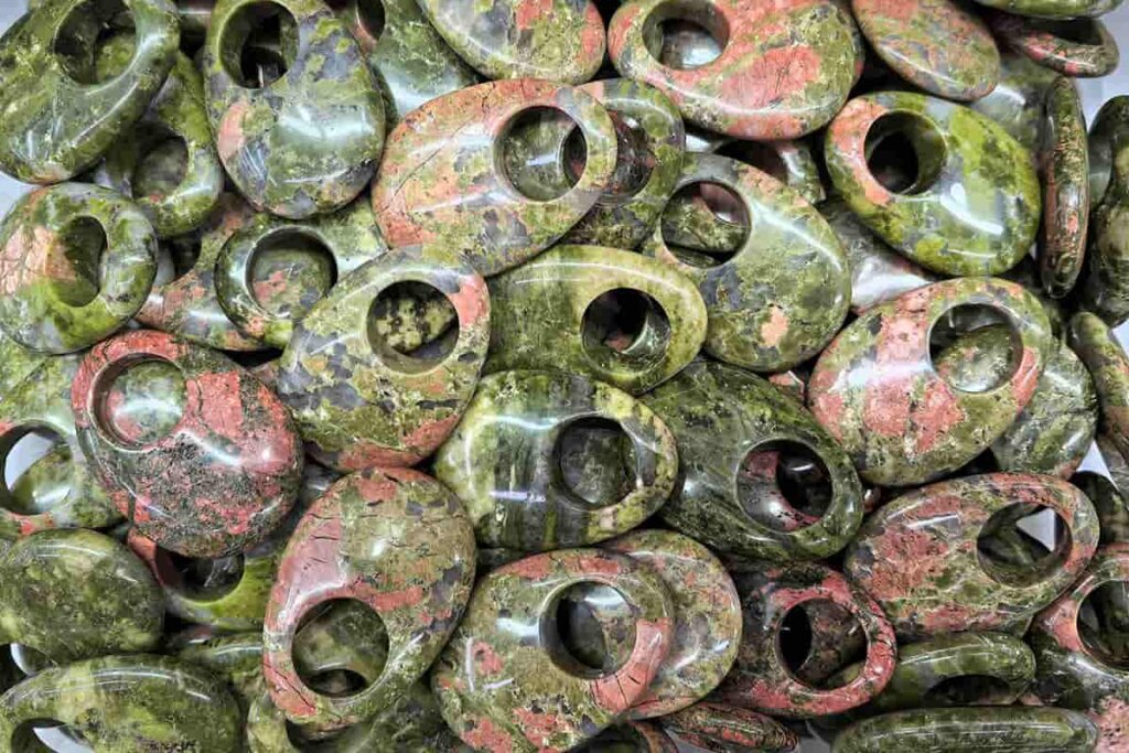 Polished Unakite Pendant featuring mottled green and salmon tones; highlights Unakite Meaning related to emotional growth and heart chakra energy.