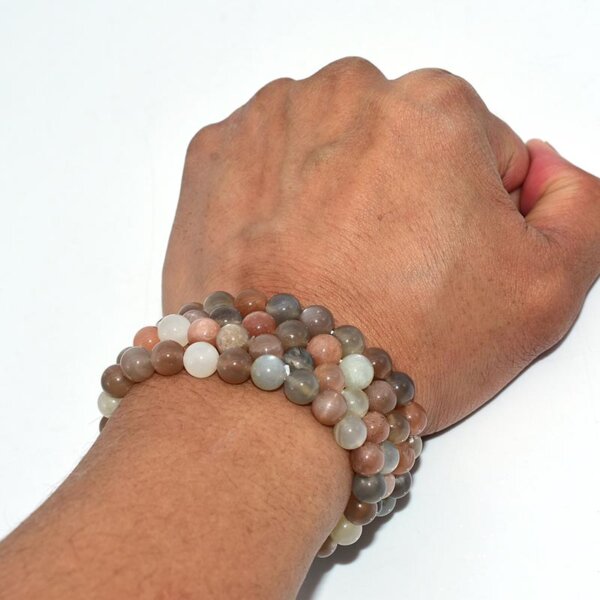 Double-stacked Peach Moonstone Bracelets on wrist displaying bead size and layering style
